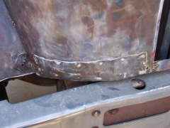 Lower front passenger side of cab